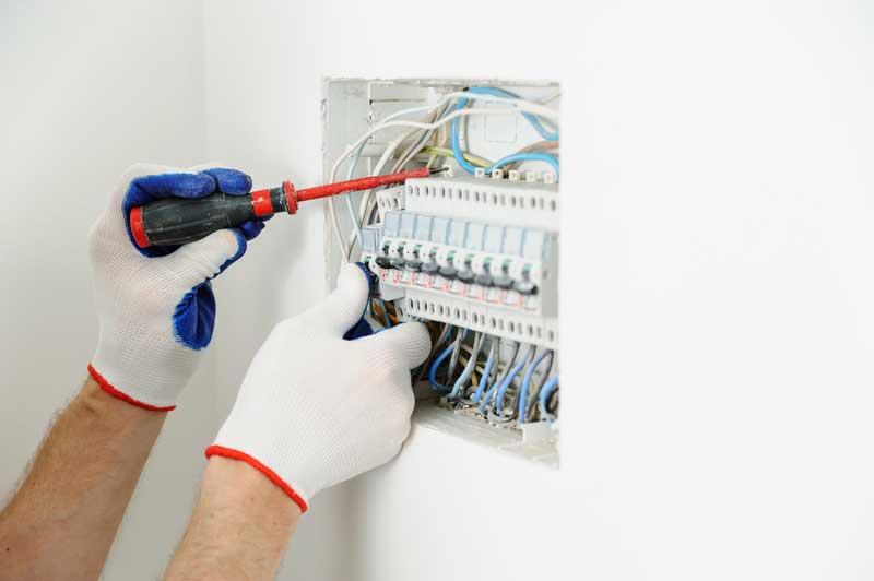 JS Electrical electrician installing fuse box.